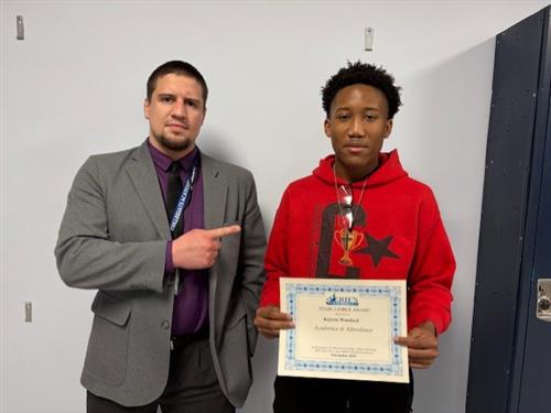 Keyion Woodard, Collegiate's Stairclimber for December, poses with his award plaque.